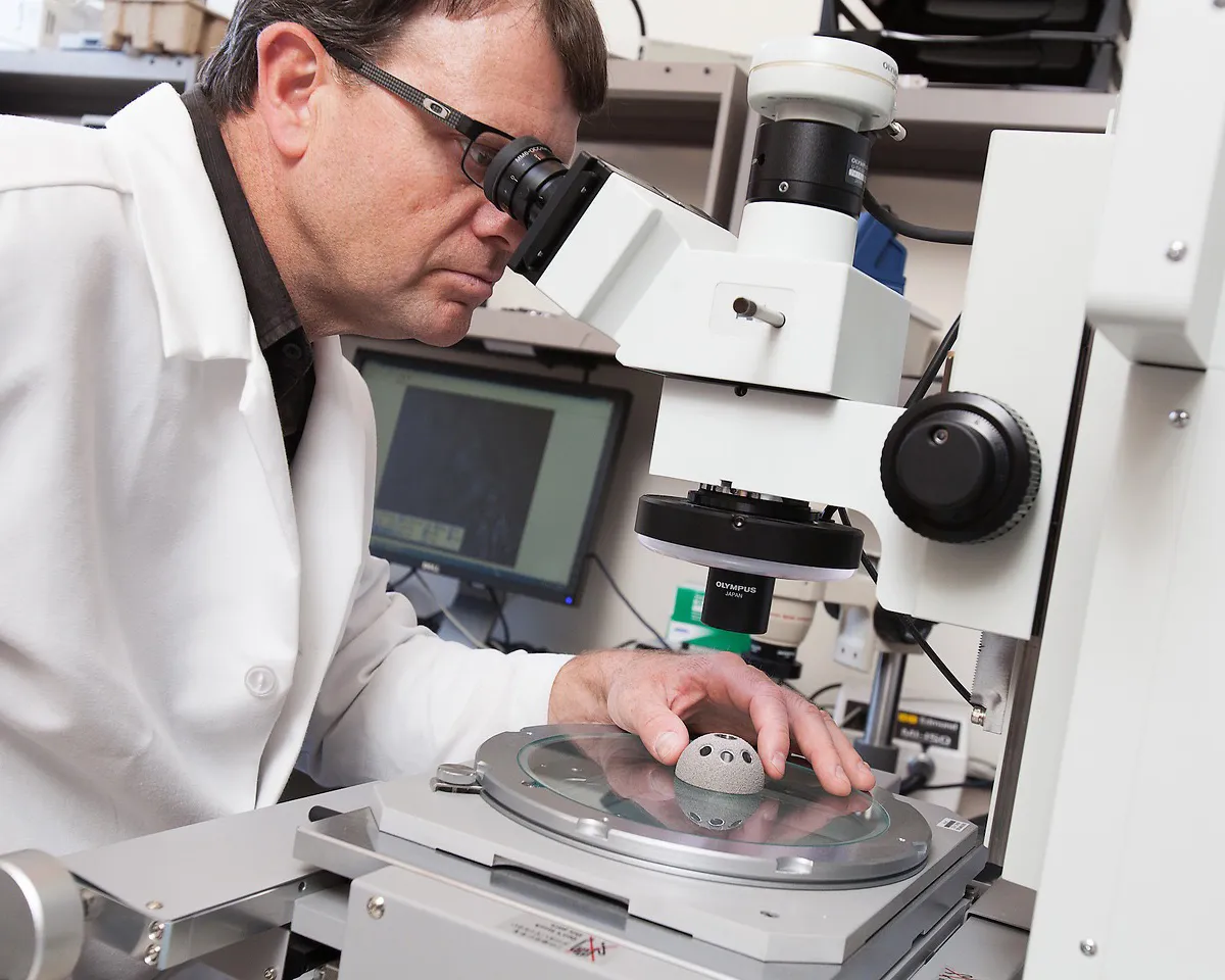 Scientist looking through a microscope