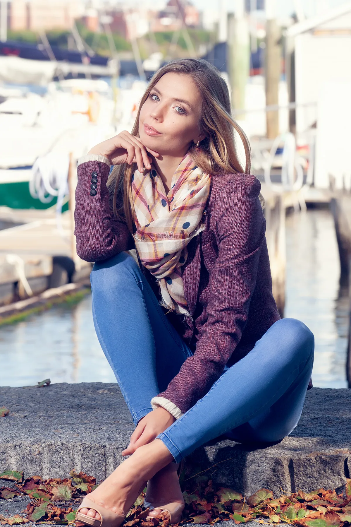 A young woman sitting outside on the curb